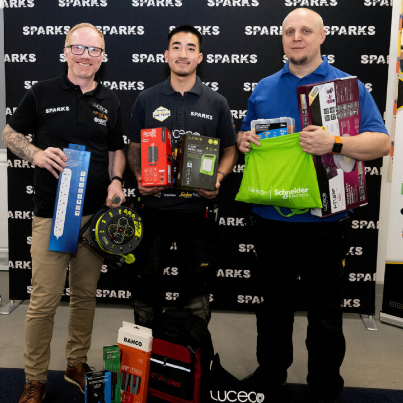 Marcus and lecturer, Lee, standing with his prizes with an industry professional