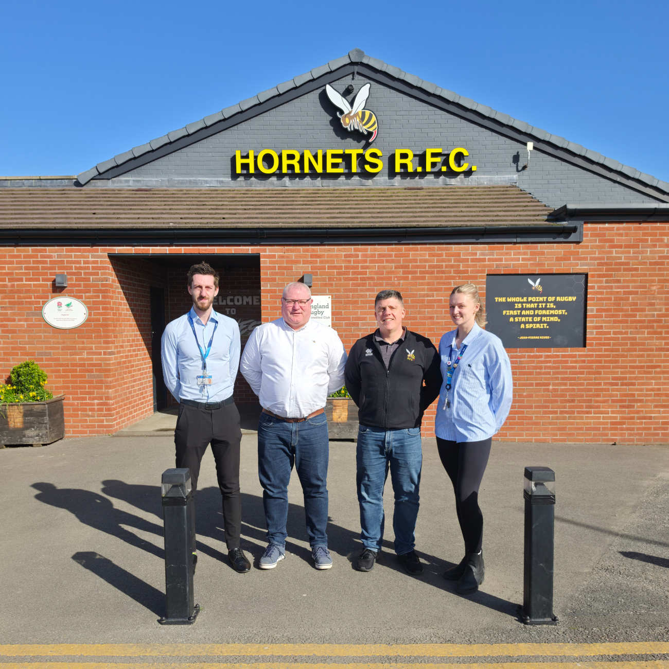 Hornets Agreement - Luke, Lee, James and Morgan standing in front of Hornets Home