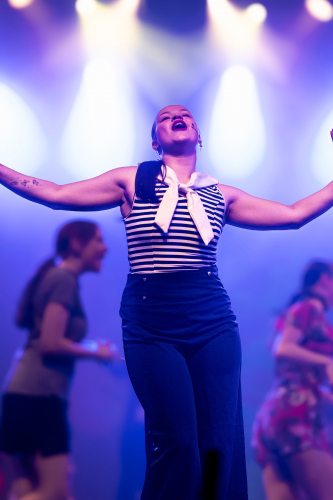 Student performing a solo dance and song