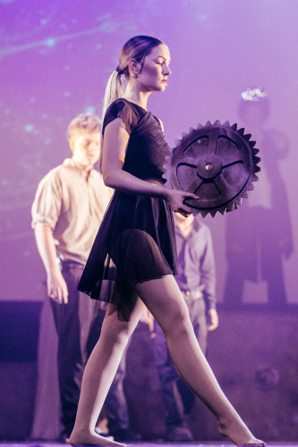 Student dancing across the stage