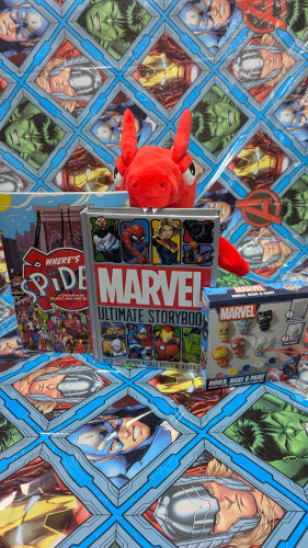 Esports stuffed dragon mascot toy posing with three marvel prizes