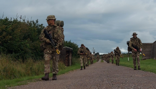 Dean and other Army cadets walking along in a line in uniform