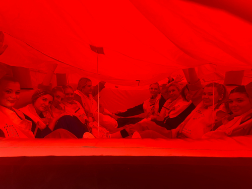 Students sat in a red life raft