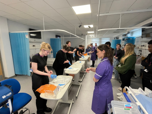 Health and Social Care learners practising how to properly open bandages with contamination