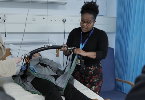 Lecturer showing students how to use a hoist
