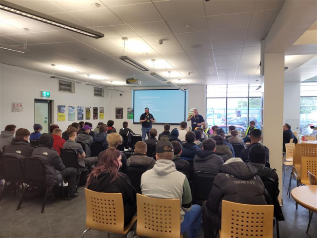 Bakers Dolphin delivering a presentation to students
