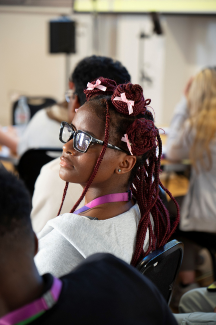 female student listening into the black history month speeches