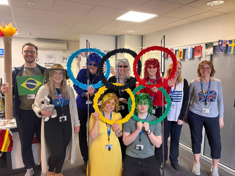 the C.I.S team standing with their self made tinsel olympic rings