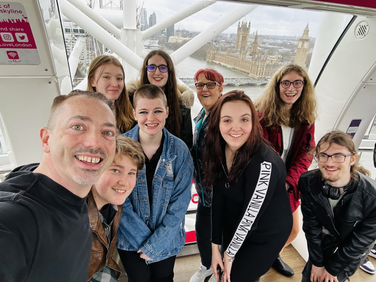 ""Joe Miller - our performing arts lecturer - posing with performing art students at night in London