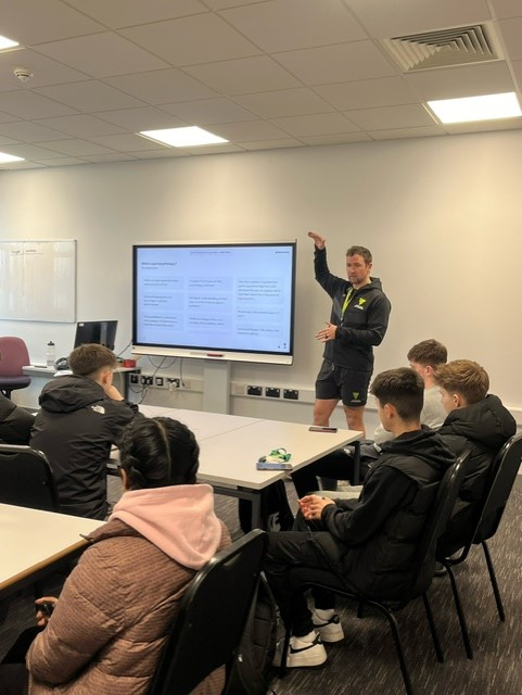 Marcus Nel - a sports psychologist - leading a workshop in a classroom of college students