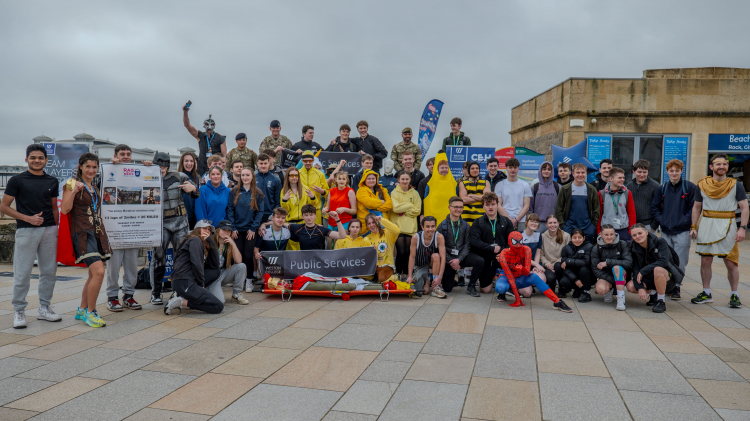 Public services students posing on the seafront just before setting off on their run