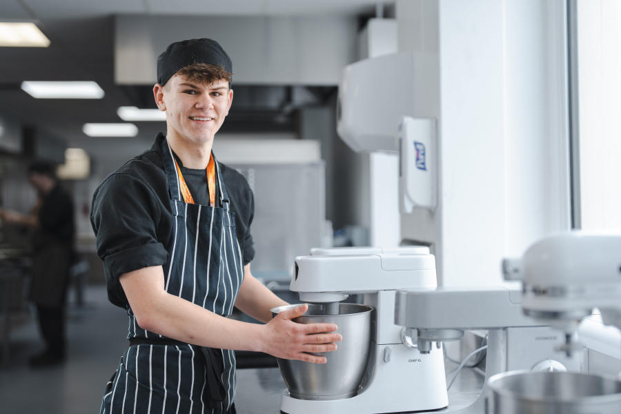 ben using a mixer in a kitchen