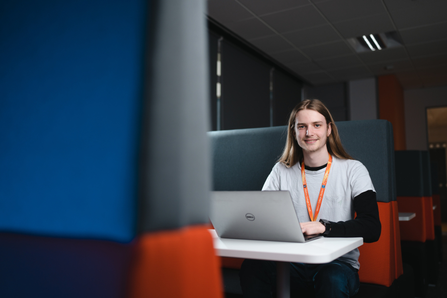 eSports student on laptop smiling
