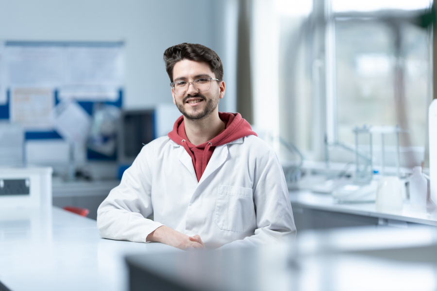 matthew sitting with lab coat on