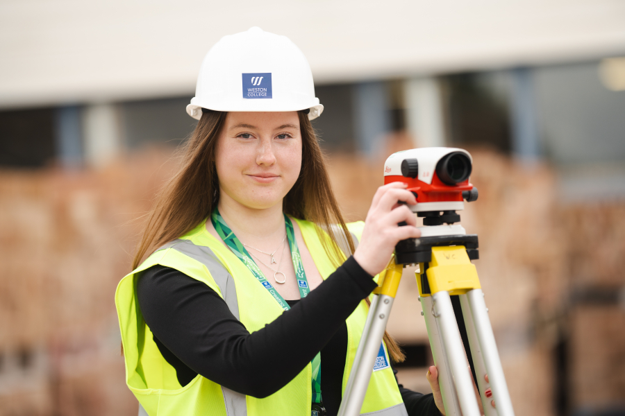 female construction student with surveyor
