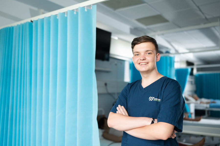 male health learner posing in health facility 