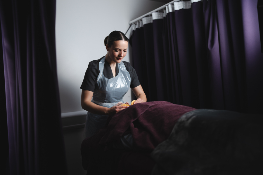 beauty therapy student giving client facial