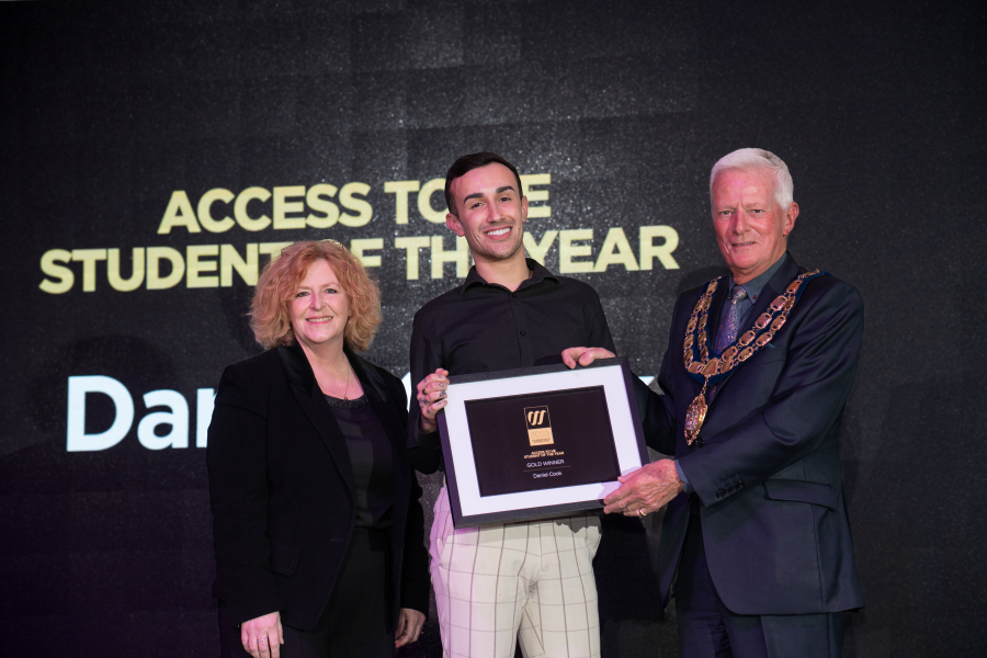Daniel collecting award