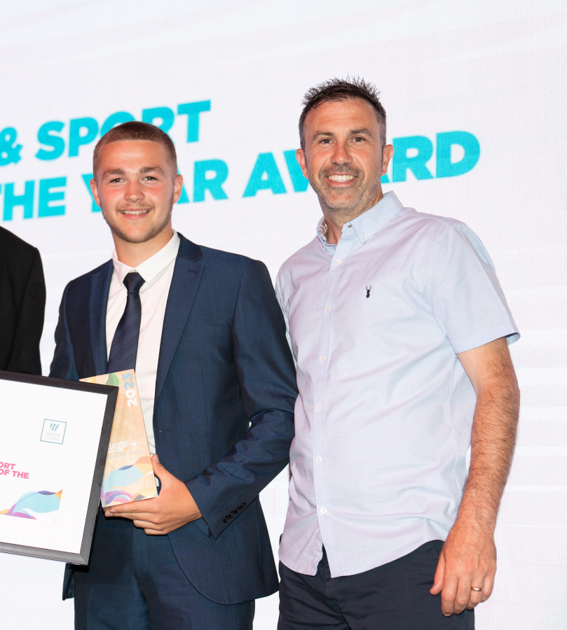 Joshua getting his award on stage