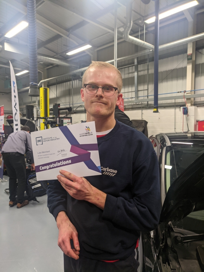 Luke holding finalists certificate